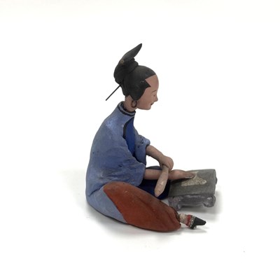 Lot 98 - A polychrome terracotta figure of a seated woman