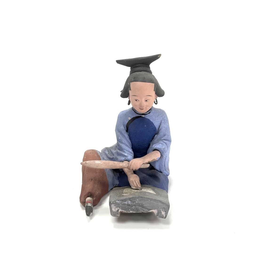Lot 98 - A polychrome terracotta figure of a seated woman