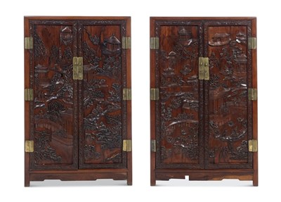 Lot 61 - A Fine and Elaborately Carved Pair of Chinese Hardwood Cabinets (Mù Jià)